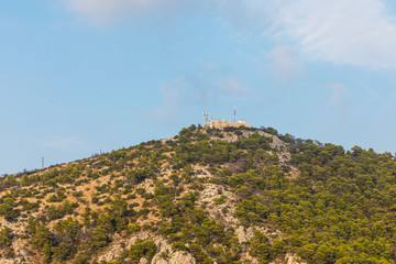 Fototapeta premium Hvar town on Hvar island, view of the old Spanish fortress on top of a mountain on a sunny day in summer. The beautiful south Mediterranean greenery in Croatia Europe. idyllic scenery
