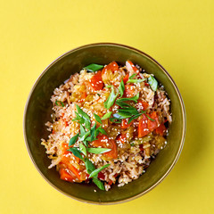 Bowl with Fried Rice and Vegetables. Traditional chinese food. Square view on yellow. Flat lay with copy space