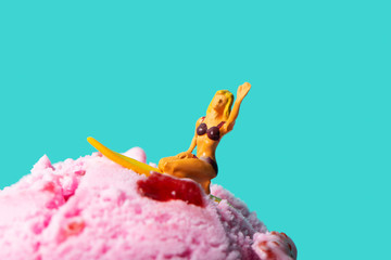 miniature surfer woman on an ice cream ball
