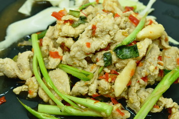 spicy and sour boiled pork with Chinese kale dressing lime garlic and chili sauce salad on plate