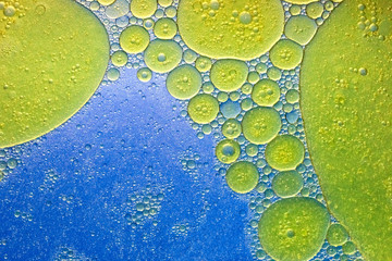 Abstract yellow and blue oil water emulsion bubble background, space for copy/text