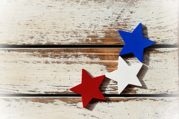 Red, white, blue star on grungy wooden background, copy space for custom text.