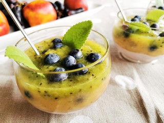 Fresh homemade organic Greek yogurt with kiwi puree, blueberry and mint. 