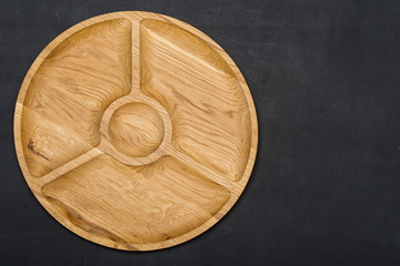 Wooden plate on wooden background.