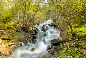 Naklejka na ściany i meble Waterfall in the Riu de la Bor in L Aldosa de Canillo in Andorra in spring.