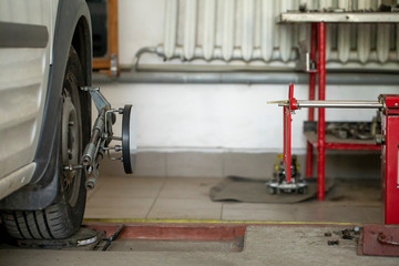 Performing wheel alignment works at the service station.