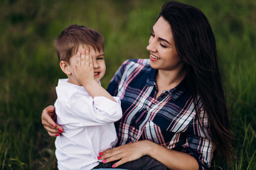 mom with a child on the green hills, mountains