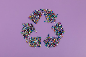 Recycle symbol consisting of small plastic pellets collected from the sea water. Rethinking the...