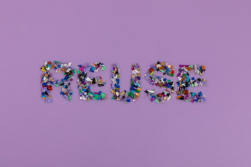Reuse text consisting of small recycled plastic pellets collected from the sea water. Rethinking...