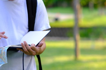 Young Man go vacation using world map and compass along with other travel accessories,Traveling with backpack 