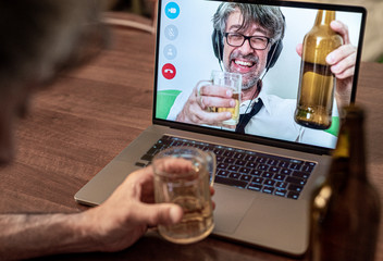 Long-time friends chat and drink beer on video call, work colleagues celebrate a long-distance...