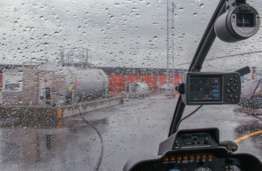 Rainy day. The view from the cockpit of the helicopter
