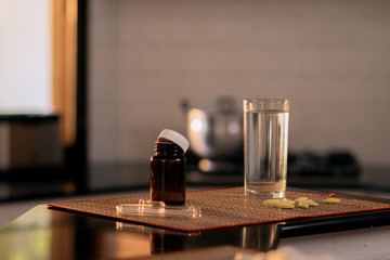 Close-up: a jar with antibiotics, a glass of water on a blurred background