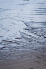 Rippled wet sand and water at the beach texture background, Adriatic sea in Italy