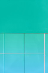 Wall with ceramic tiles in a neo mint green colored effect background. White lines in between the tiles. Light blue gradient. Simple geometric style. Close up, trend color