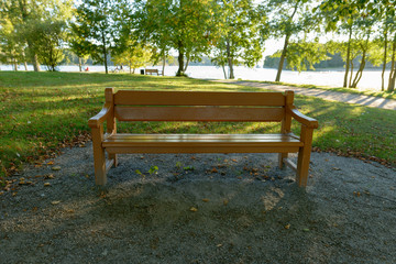 Portrait of furnished wooden bench in the park