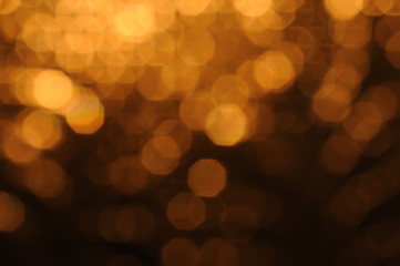 Dark golden and brown abstract bokeh lights. defocused background