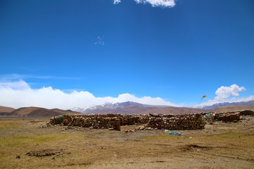 Fototapeta na wymiar The magnificent scenery of the Everest Scenic Area, the brown hillside, the snowy mountains in the distance, the blue sky and white clouds, the road to the distance