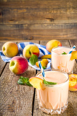 Summer breakfast drink, fresh blended peach smoothie, peach yogurt with nectarine fruit slices,...
