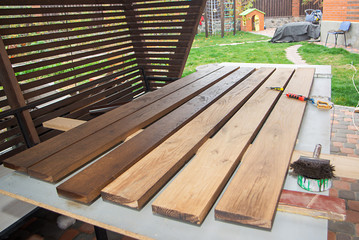 A man holding brush and painting on the wooden table