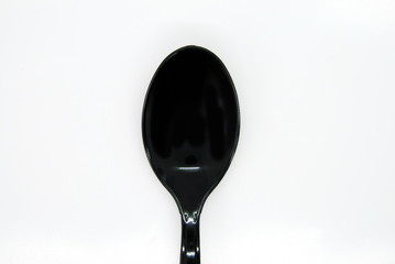 black spoon on white background
