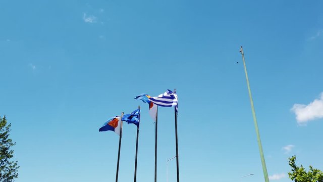 European and Greek flags waving on a pole on the port of Thessaloniki in Greece