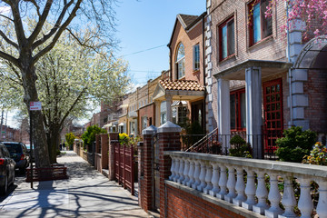 Row of Beautiful Homes along a Sidewalk during Spring in Astoria Queens New York