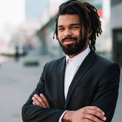 Handsome employee smiling medium shot. Black business man.