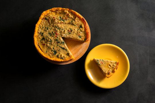 Vegetable And Cheese Cake And A Portion Of The Same View From Above On A Black Background