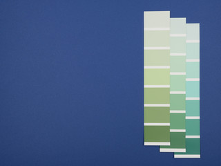 The shades of green on a blue background. The palettes of green colors.