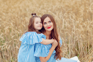 two girls in a wheat field