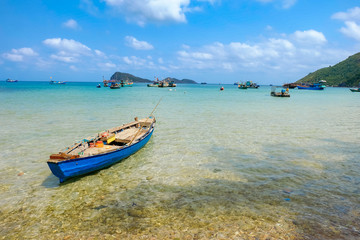 Fototapeta na wymiar The beautiful tropical beach of Nam Du, the paradise island with the coast, white sand, clean water, boat, forest and blue sky. Nam Du island is a popular tourist destination in Kien Giang, Vietnam