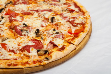Pizza on a wooden board on a white background