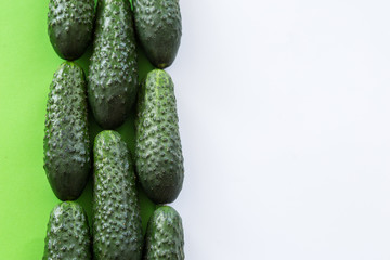 Cucumbers on a white and green background.
