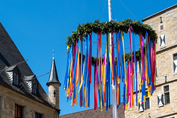 maypole in front of European cathedral in spring time  - obrazy, fototapety, plakaty