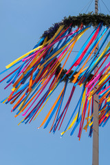colourful maypole blowing in the wind  - obrazy, fototapety, plakaty