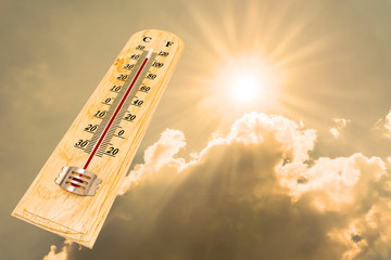 The thermometer showing high temperatures with sunlight background
