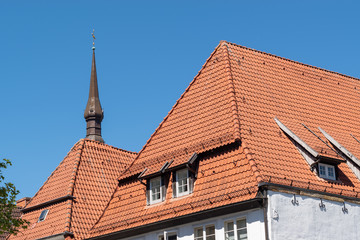 German architecture rooves and church spire against blue sky