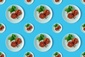 Seamless pattern of tasty eastern sweets kozinaki made from peanuts and honey on a blue background.