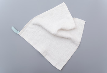White bath towel on gray background