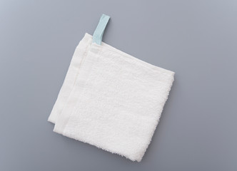 White bath towel on gray background