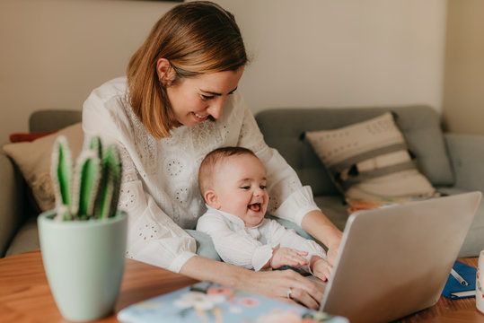 young business mother works from home with her cute baby