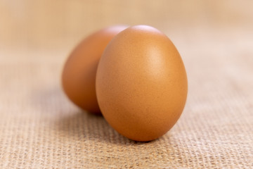  Raw Chicken eggs in cardboard egg box on brow mat. Eggs in the package.