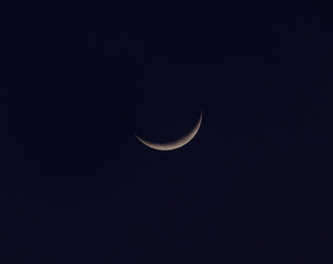 Obraz na płótnie Canvas The gorgeous crescent moon glowing in the dark night sky...