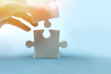 Conceptual image of jigsaw puzzle in his hands. Help, search for solutions, ideas, and business support
