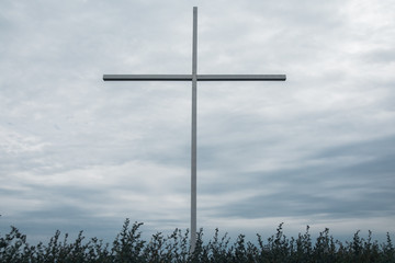 big cross with sea on the background