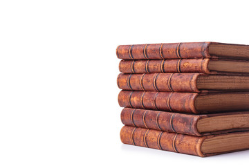A stack of old books bound in brown leather, isolated on a white background. Space for text