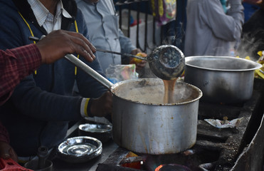 man making tea, on a street in nainital mall road uttrakhand, Indian chai