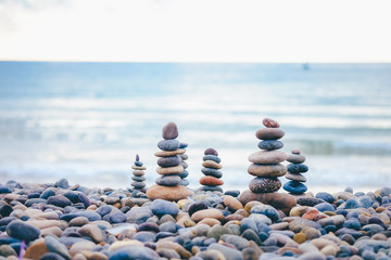 Close up of rocks stacked one on top of another with soft selective focus. Stones are naturally balanced on the background of the sea. High-quality free stock images of rocks and landscapes