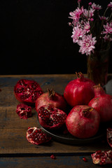 Ripe pomegranates on wooden table